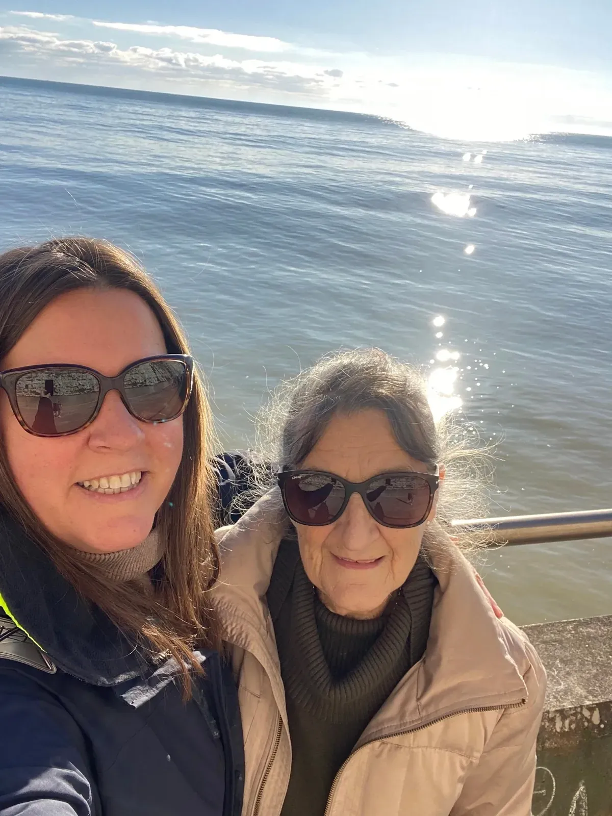 Louise Callin and her mum sharing a moment by the sea